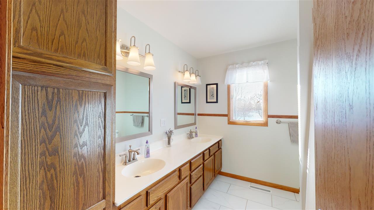 3028 South Golf Road Stockton, IL 61085 - Photo 21 of 26 a bathroom with double vanity and mirrors