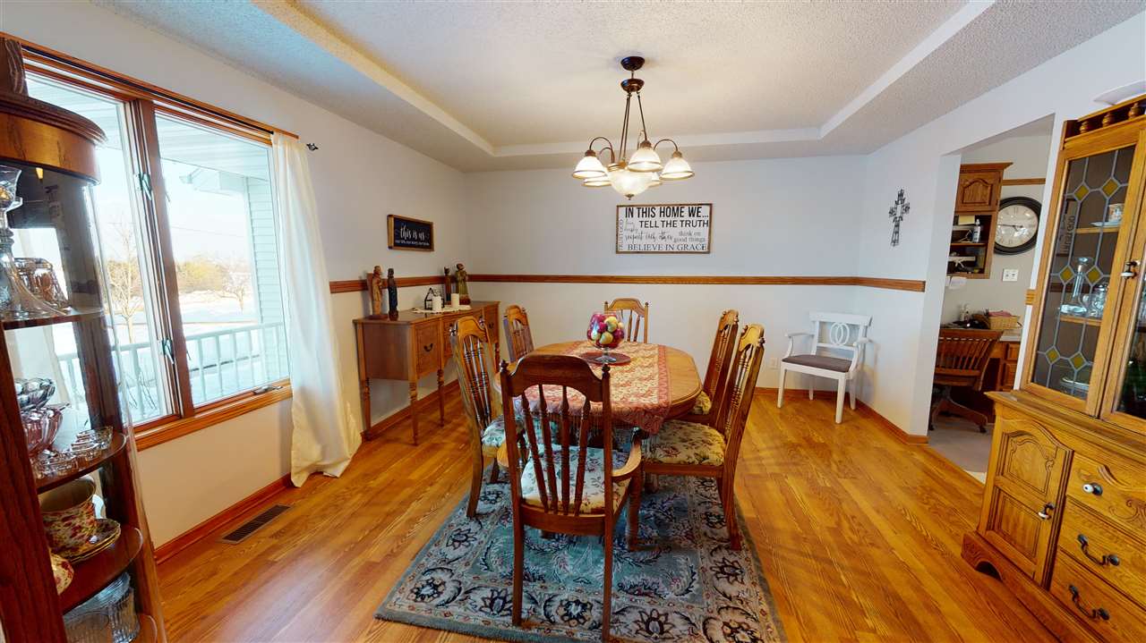 3028 South Golf Road Stockton, IL 61085 - Photo 4 of 26 a view of a dining room with furniture a chandelier and wooden floor