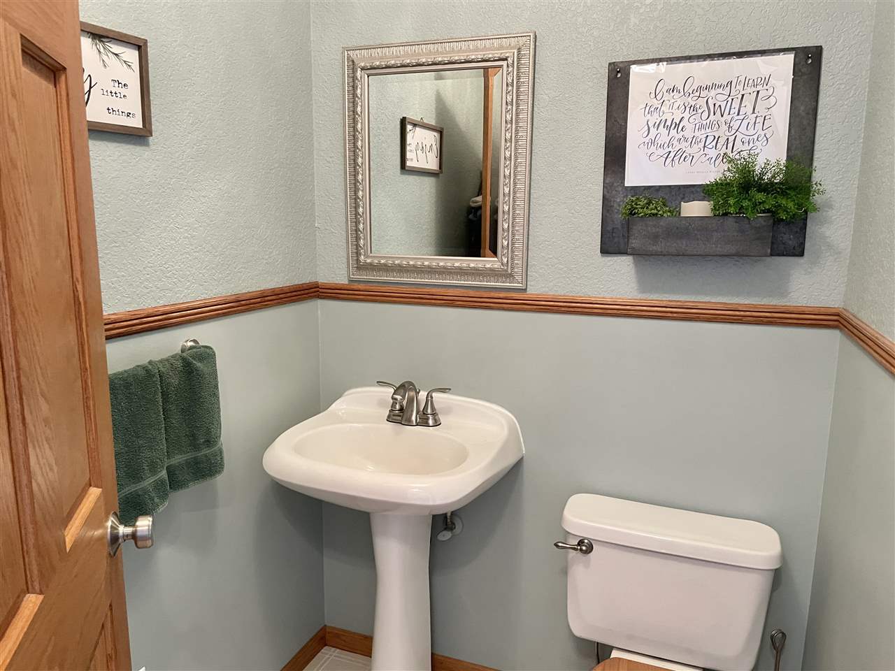 3028 South Golf Road Stockton, IL 61085 - Photo 6 of 26 a bathroom with a toilet sink and mirror