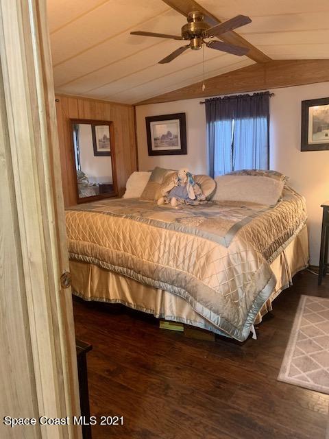 3315 Brockett Road Mims, FL 32754 - Photo 13 of 27 a bedroom with a bed and wooden floor