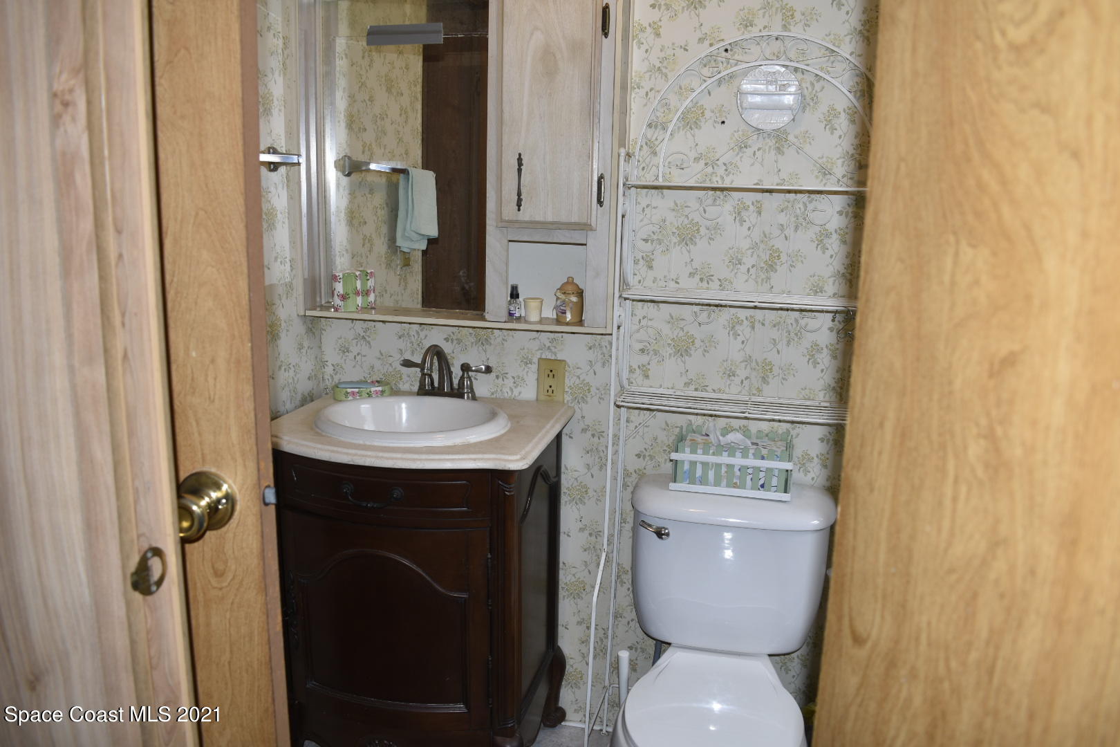 3315 Brockett Road Mims, FL 32754 - Photo 16 of 27 a bathroom with a toilet sink and mirror