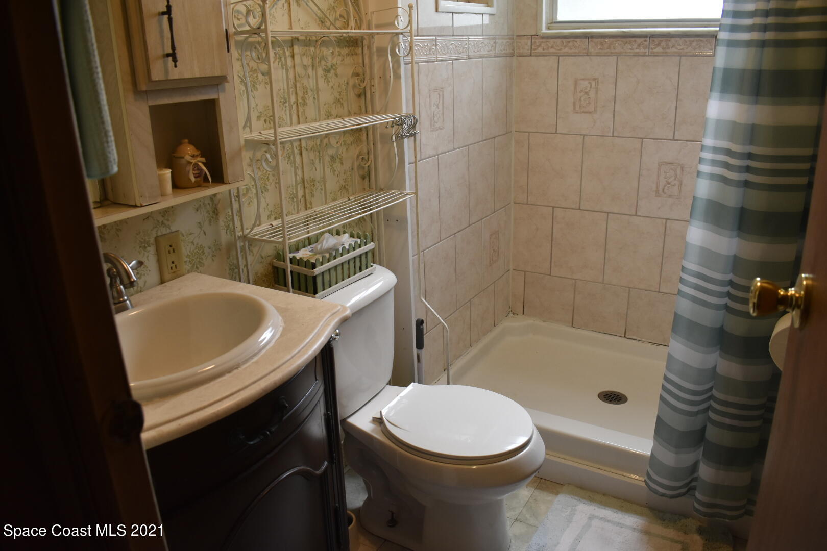 3315 Brockett Road Mims, FL 32754 - Photo 17 of 27 a bathroom with a sink a toilet and shower