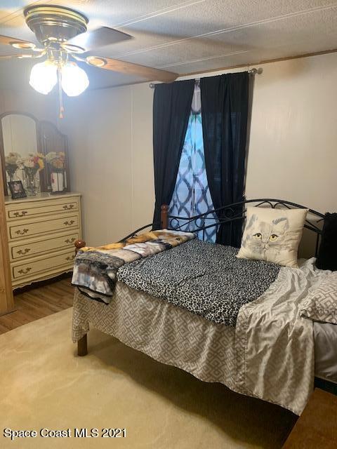 3315 Brockett Road Mims, FL 32754 - Photo 20 of 27 a bedroom with a bed and a chandelier