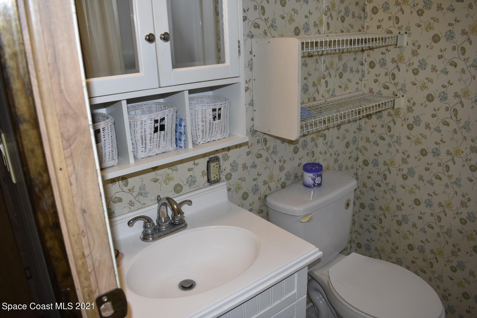 3315 Brockett Road Mims, FL 32754 - Photo 22 of 27 a bathroom with a sink a toilet and mirror