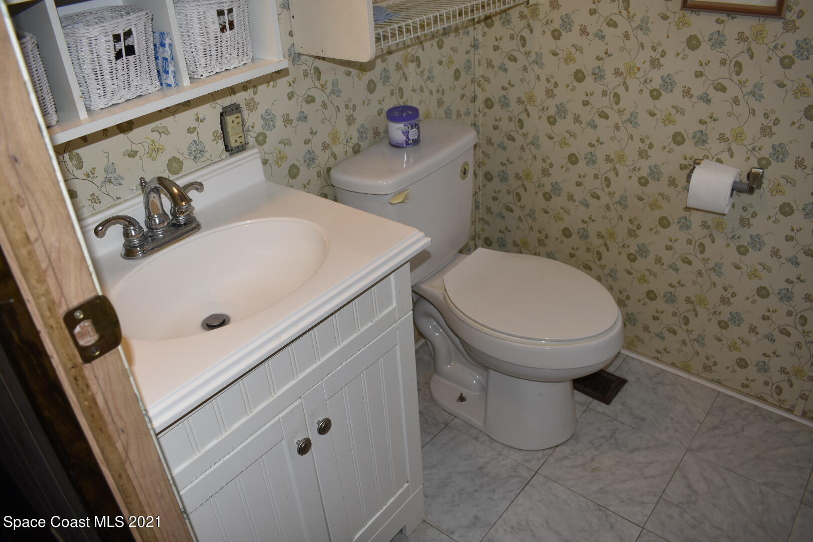 3315 Brockett Road Mims, FL 32754 - Photo 23 of 27 a bathroom with a sink a toilet and a mirror