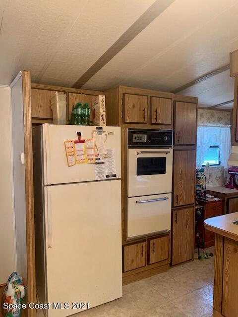 3315 Brockett Road Mims, FL 32754 - Photo 7 of 27 a white refrigerator freezer and a stove sitting inside of a kitchen