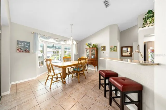 a dining room with furniture and window