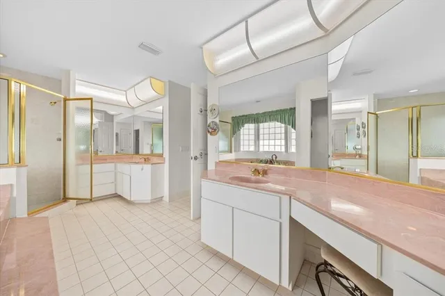 a spacious bathroom with a granite countertop sink mirror and bathtub