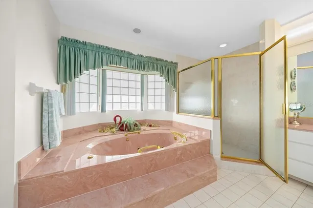 a spacious bathroom with a tub and shower