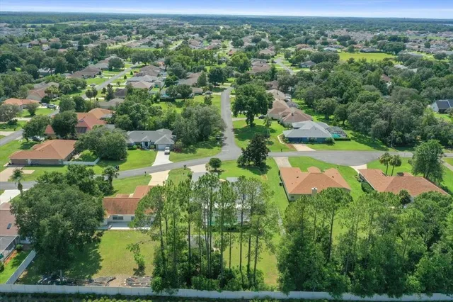 an aerial view of residential houses with outdoor space and street view