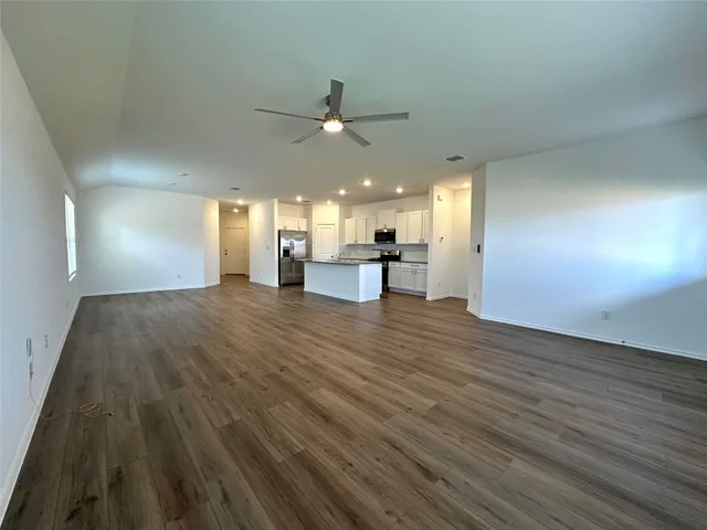 a view of kitchen with cabinets and wooden floor