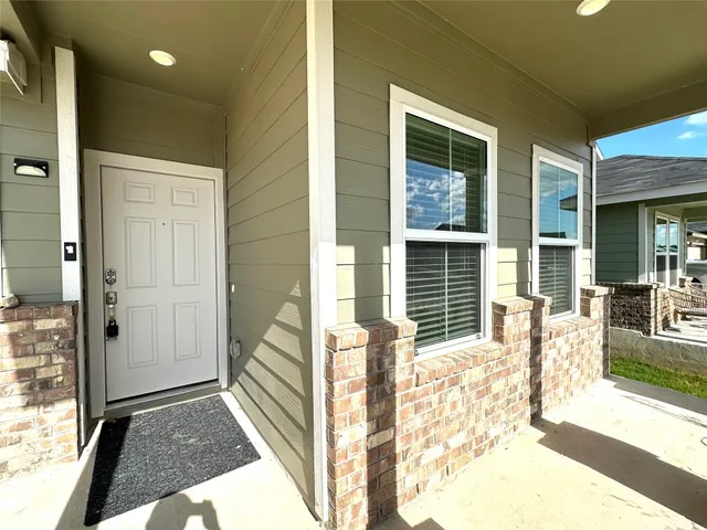 a view of porch with a bench in front of house