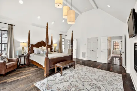 a living room with a bed furniture and a large window