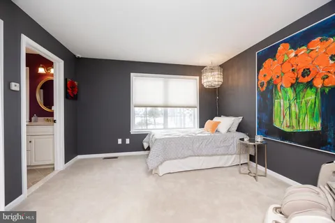 a room with lots of wooden furniture and a window