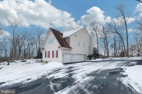a view of a house with a snow in the yard
