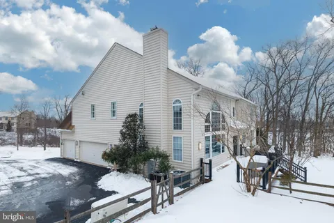 a view of a house with snow on the road