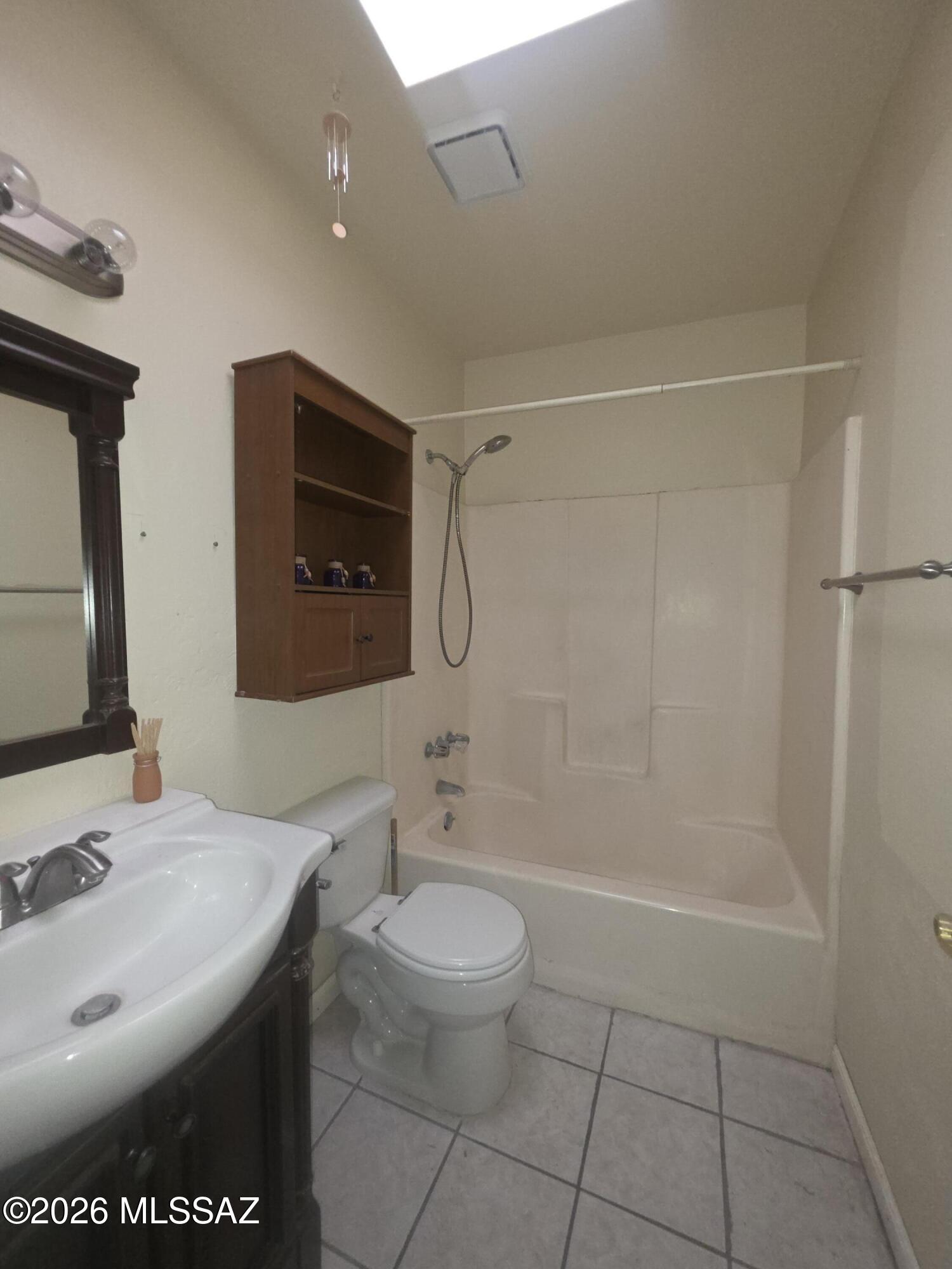 211 West Roger Road, Unit 24 Tucson, AZ 85705 - Photo 4 of 24 a bathroom with a sink a toilet and shower