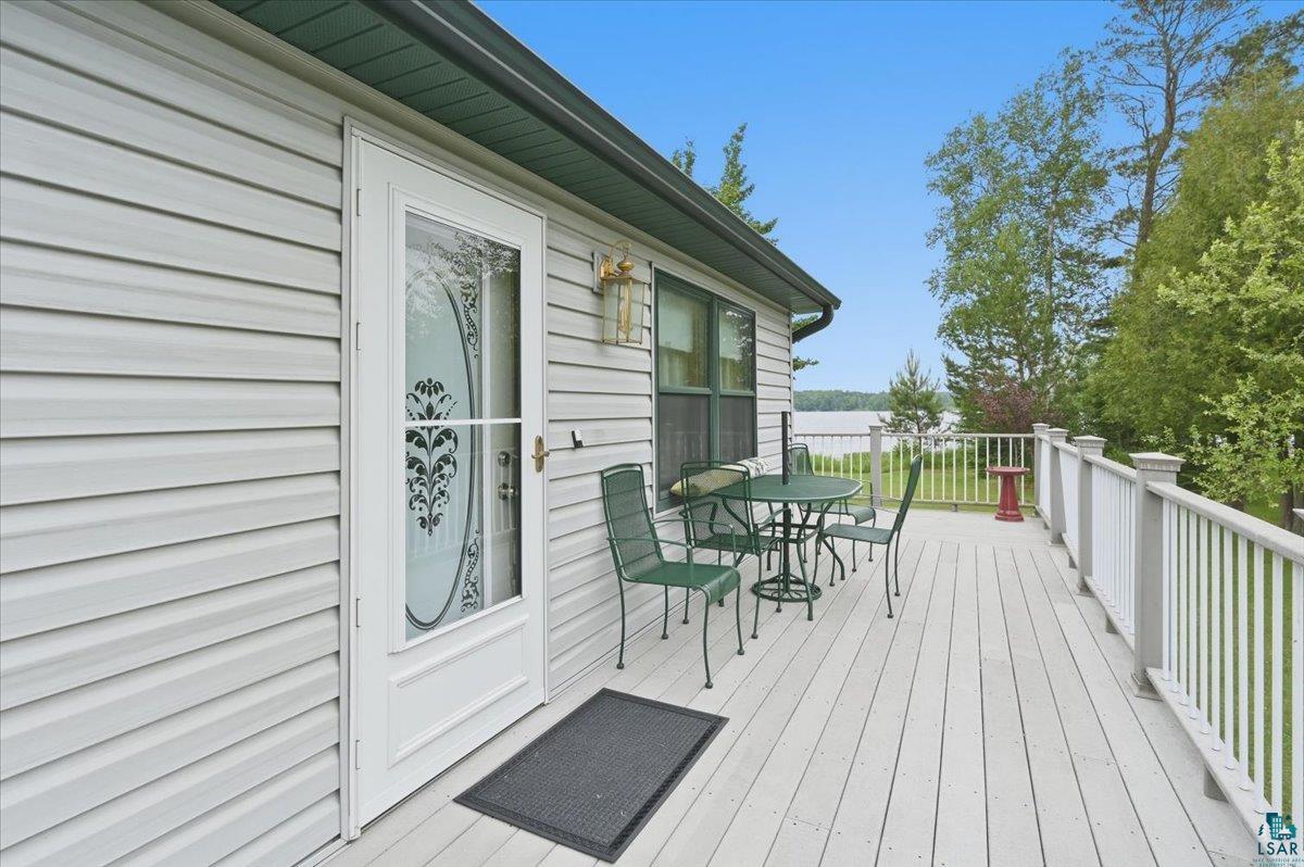 8162 South Dowling Road West Superior, WI 54880 - Photo 13 of 15 Exterior deck featuring composite decking, white railing, and a clear glass storm door with decorative etching