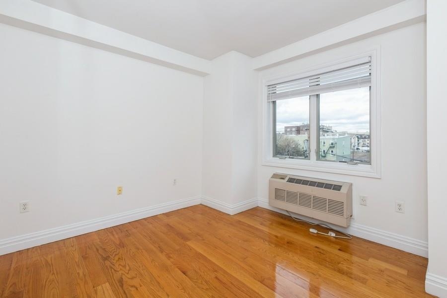 125 43rd Street, Unit 504 Union City, NJ 07087 - Photo 9 of 16 a bedroom with a bed and a window
