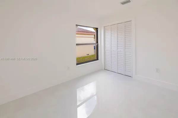 a view of an empty room with a window