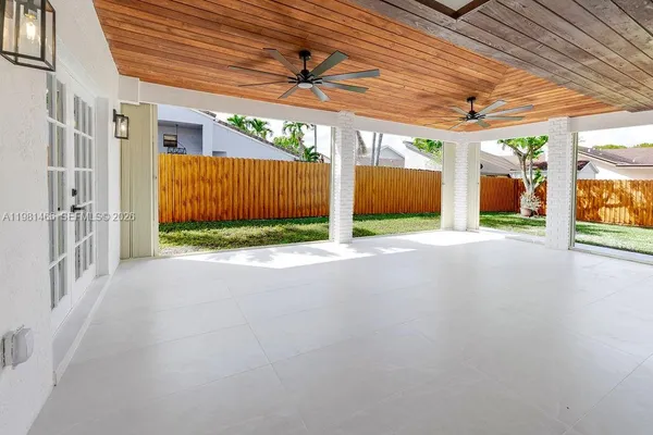 a view of a room with wooden floor and a porch
