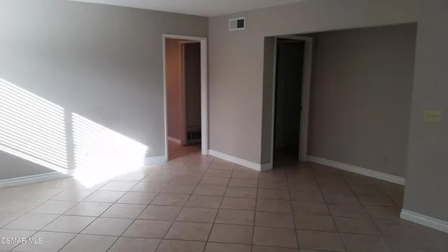 an empty room with windows and entrance