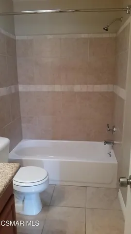a bathroom with a toilet and a bathtub