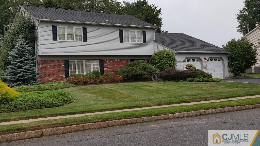 53 Higgins Road Old Bridge, NJ 08857 - Photo 1 of 17 a front view of a house with a garden