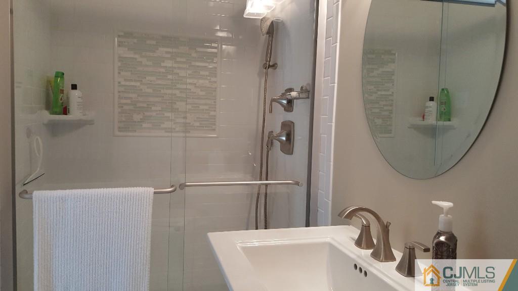 53 Higgins Road Old Bridge, NJ 08857 - Photo 11 of 17 a bathroom with a sink and a mirror