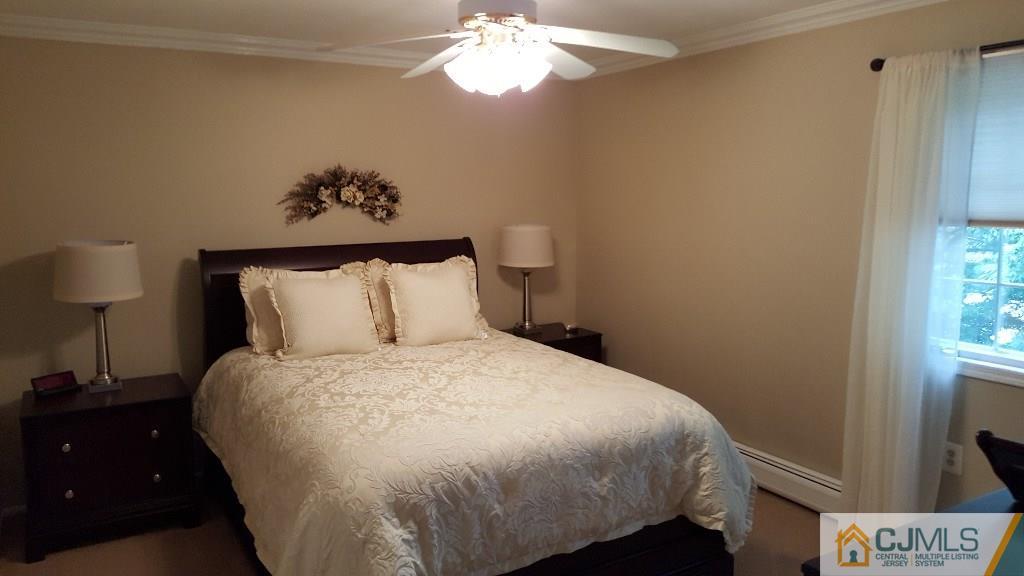 53 Higgins Road Old Bridge, NJ 08857 - Photo 17 of 17 a bedroom with a bed and a chandelier