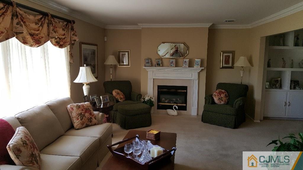 53 Higgins Road Old Bridge, NJ 08857 - Photo 3 of 17 a living room with furniture and a fireplace