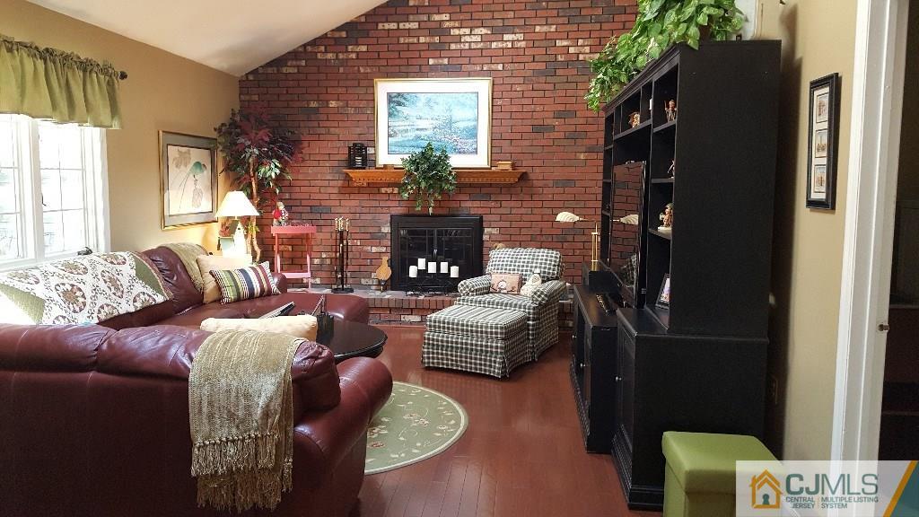 53 Higgins Road Old Bridge, NJ 08857 - Photo 9 of 17 a living room with furniture and a fireplace