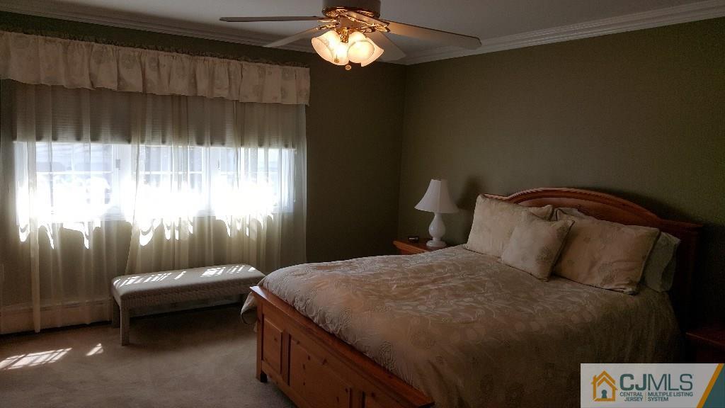 53 Higgins Road Old Bridge, NJ 08857 - Photo 10 of 17 a bedroom with a bed and a window