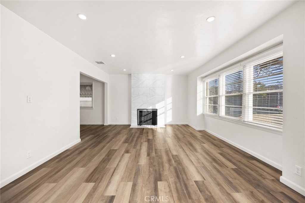 141 Fano Street Arcadia, CA 91006 - Photo 4 of 22 a view of empty room with wooden floor and fireplace