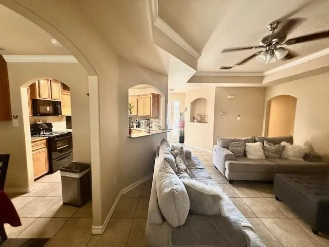 a living room with furniture and a kitchen