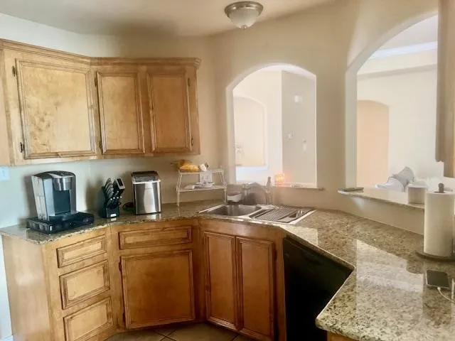 a kitchen with stainless steel appliances granite countertop a sink stove and cabinets