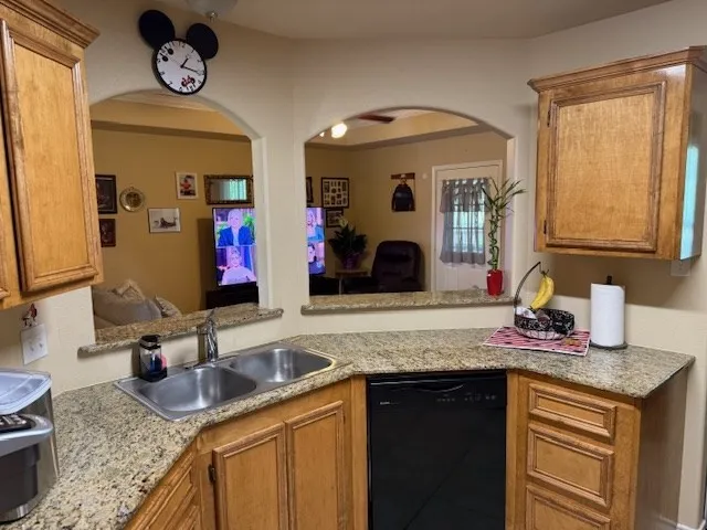 a bathroom with a granite countertop sink a mirror and vanity