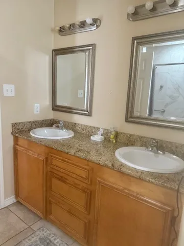 a bathroom with a granite countertop sink a mirror and a