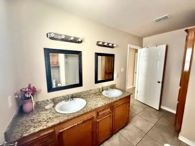 a bathroom with sinks granite countertop a sink and a mirror