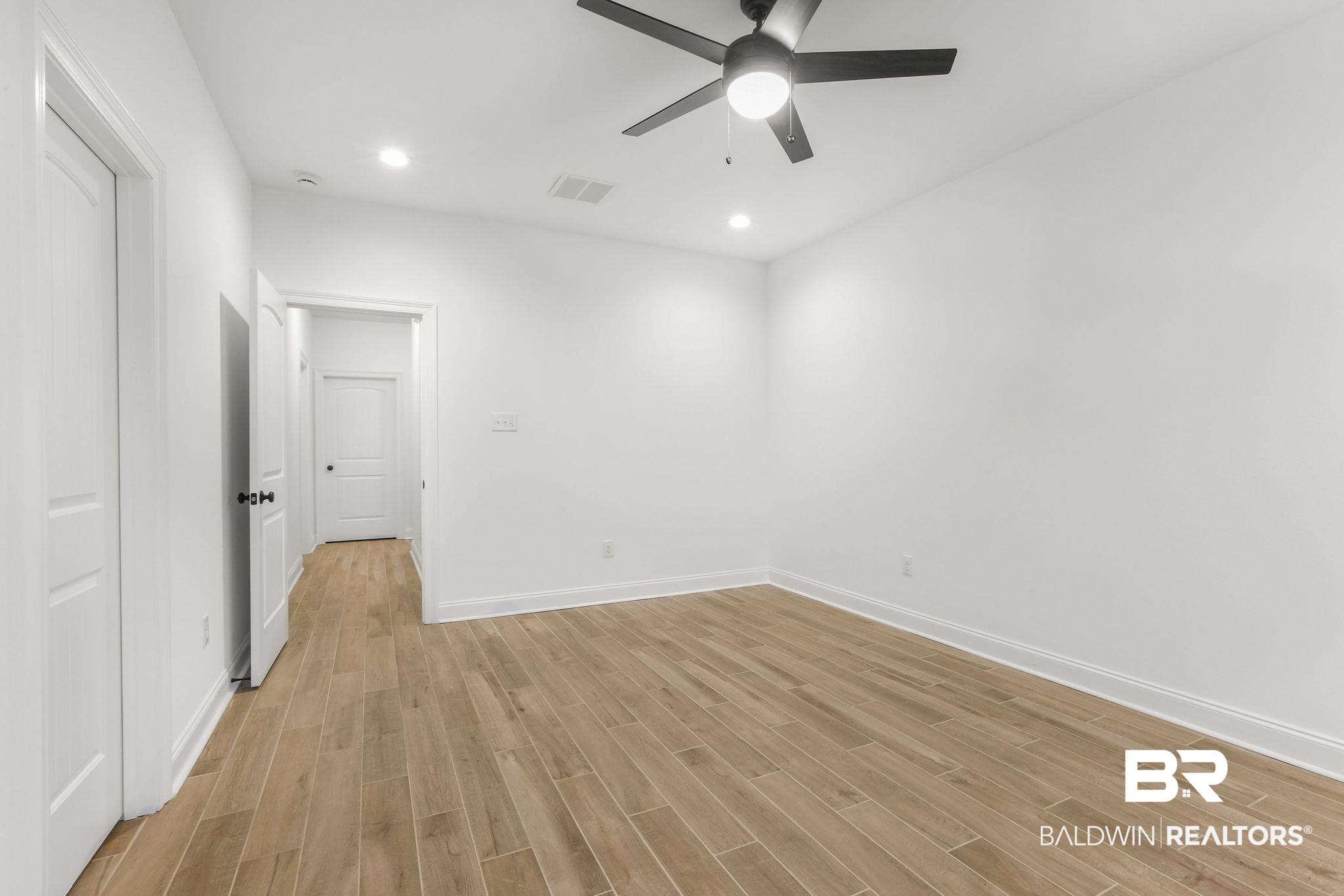 9855 Chipper Lane Foley, AL 36535 - Photo 27 of 48 Unfurnished room featuring light wood-type flooring and ceiling fan