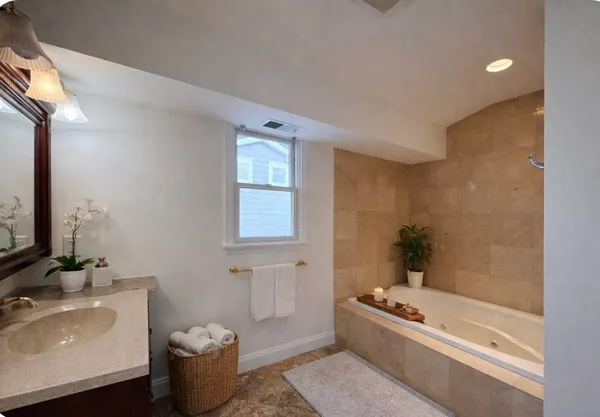 a bath room with a bath tub and a sink