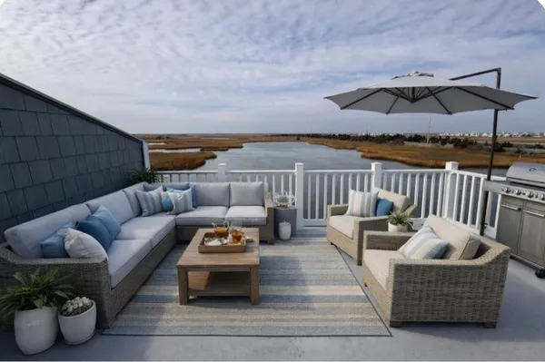 a outdoor living space with furniture and umbrella