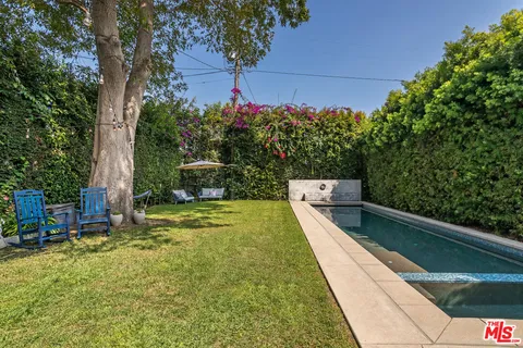 a view of a house with swimming pool and sitting area