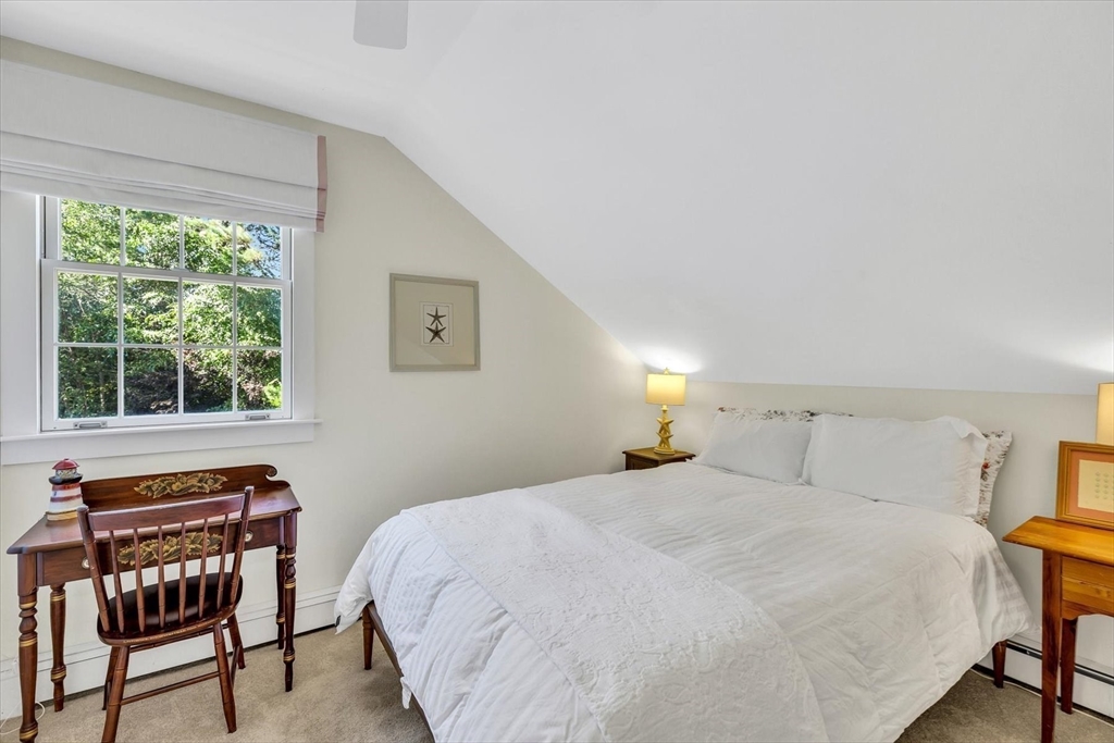 665 Route 6A Sandwich, MA 02537 - Photo 26 of 42 a bedroom with a bed and a window