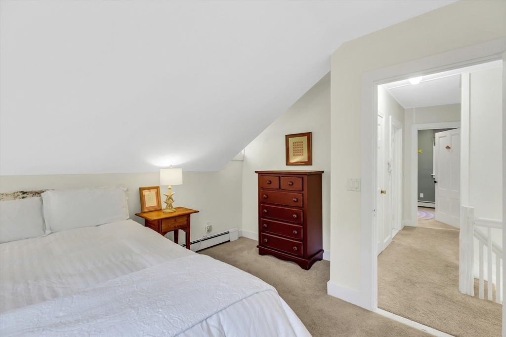 665 Route 6A Sandwich, MA 02537 - Photo 27 of 42 a bedroom with a bed and a dresser