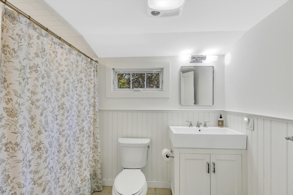 665 Route 6A Sandwich, MA 02537 - Photo 28 of 42 a bathroom with a sink mirror and toilet