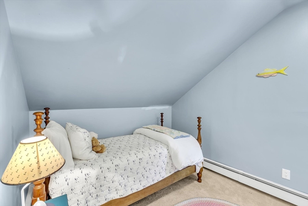 665 Route 6A Sandwich, MA 02537 - Photo 29 of 42 a bedroom with a bed and a window