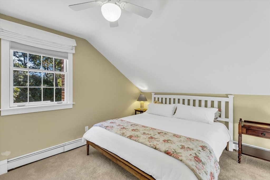 665 Route 6A Sandwich, MA 02537 - Photo 30 of 42 a bedroom with a large bed and a window