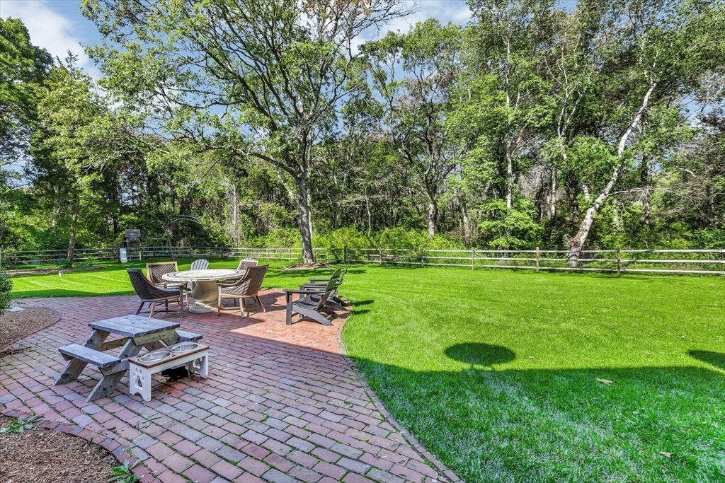 665 Route 6A Sandwich, MA 02537 - Photo 32 of 42 a view of a backyard with sitting area