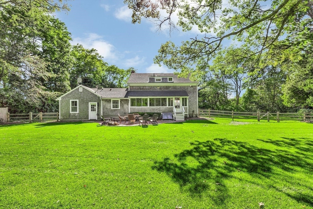 665 Route 6A Sandwich, MA 02537 - Photo 33 of 42 a front view of a house with a garden